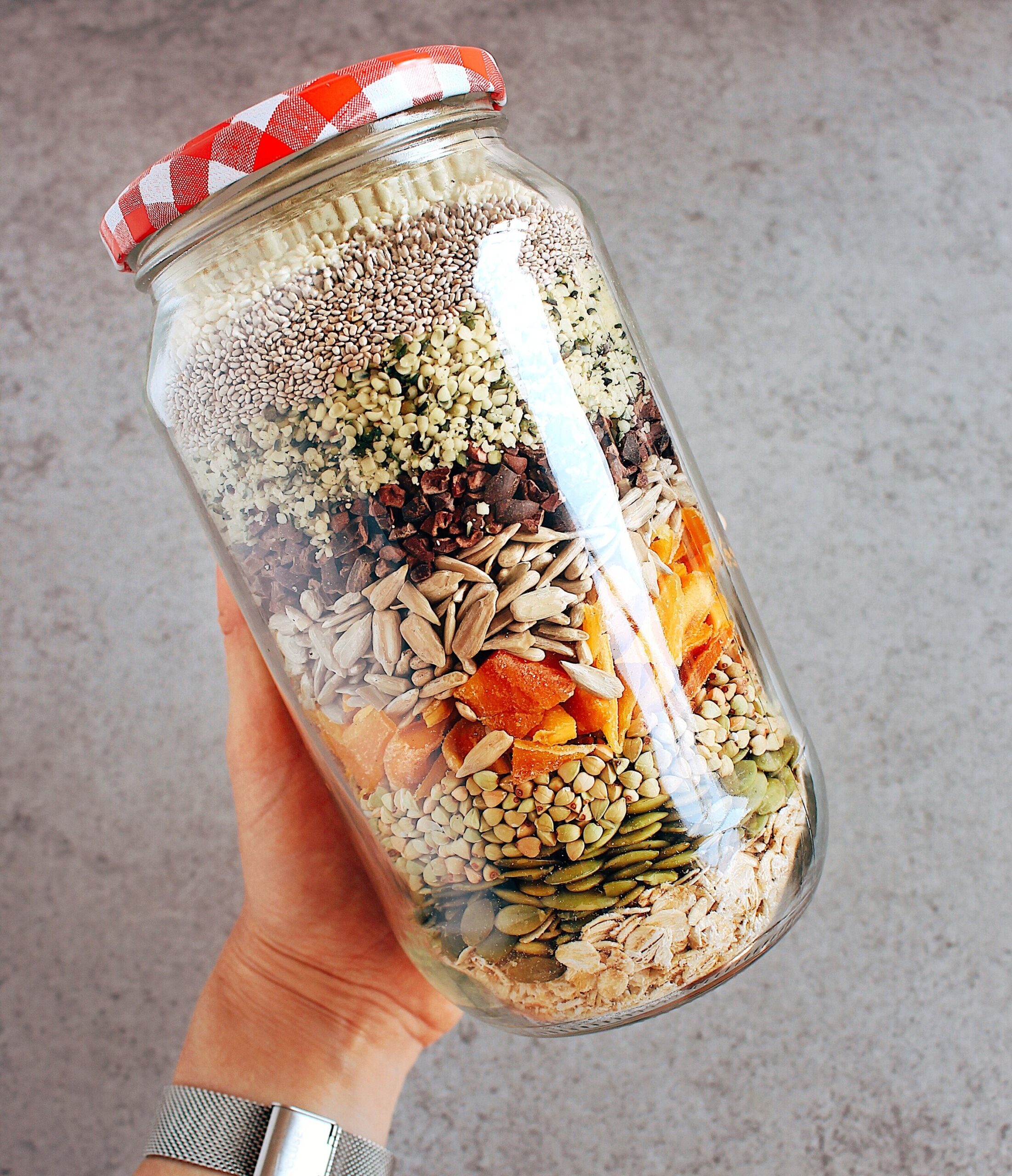 Superfood Burcha Dry Mix (missing flaxseeds and sultanas). From the top: sesame seeds, chia seeds, hemp seeds, cacao nibs, sunflower seeds, dried mango, buckwheat groats, pumpkin seeds, oats.